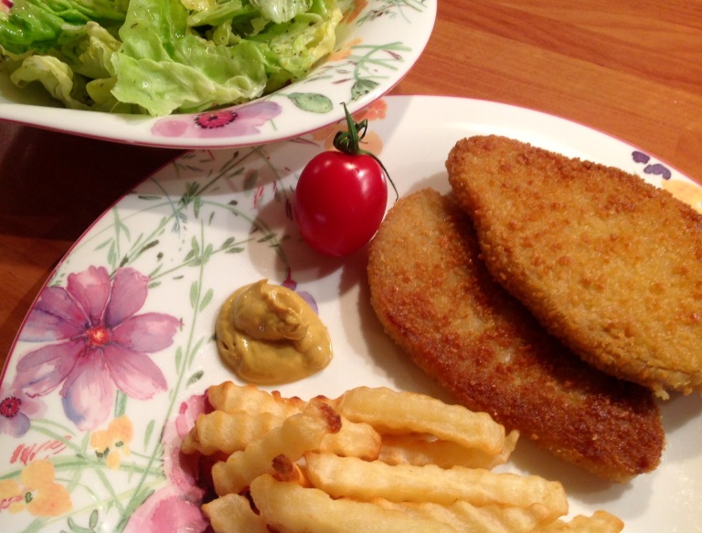 Vegan schnitzel, potato fries and green salad