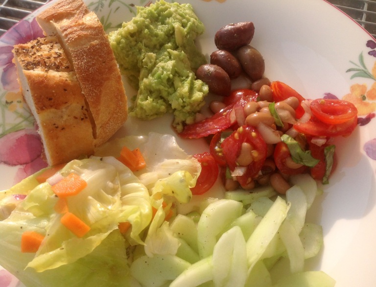Guacamole, salad, olives and bread